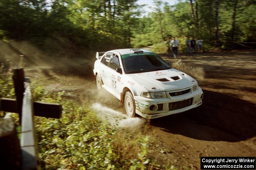 Seamus Burke / Frank Cunningham Mitsubishi Lancer Evo IV powers out of a sharp left-hander on SS13 (Steamboat).