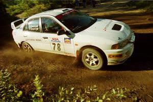 Paul Dunn / Rebecca Dunn Mitsubishi Lancer Evo IV powers out of a sharp left-hander on SS13 (Steamboat).