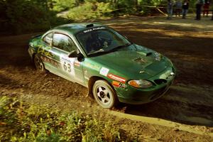 Tad Ohtake / Martin Dapot Ford Escort ZX2 powers out of a sharp left-hander on SS13 (Steamboat).