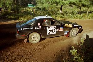 Dave Hintz / Rick Hintz Mazda RX-7 powers out of a sharp left-hander on SS13 (Steamboat).
