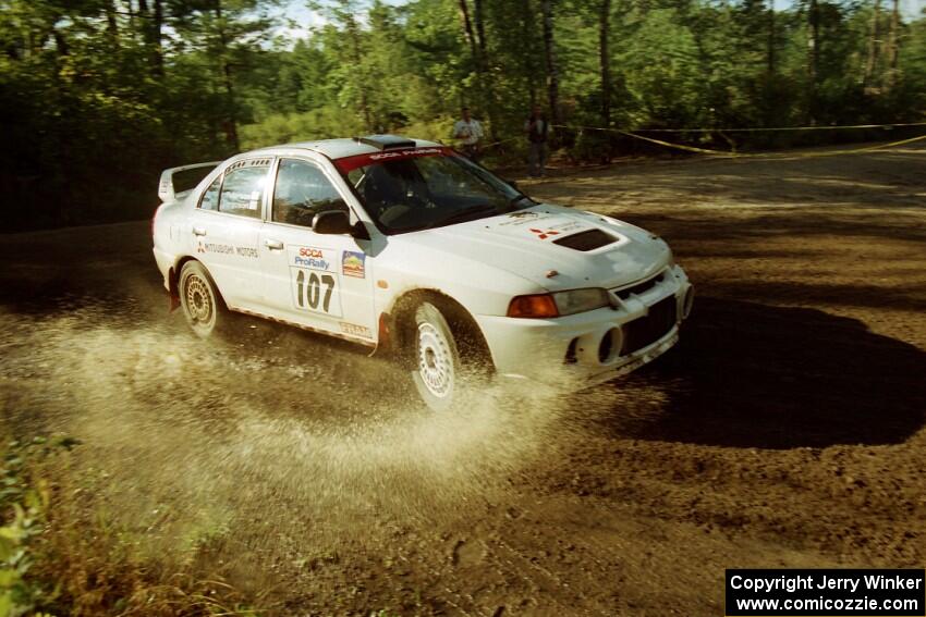 Tim Paterson / Scott Ferguson Mitsubishi Lancer Evo IV powers out of a sharp left-hander on SS13 (Steamboat).