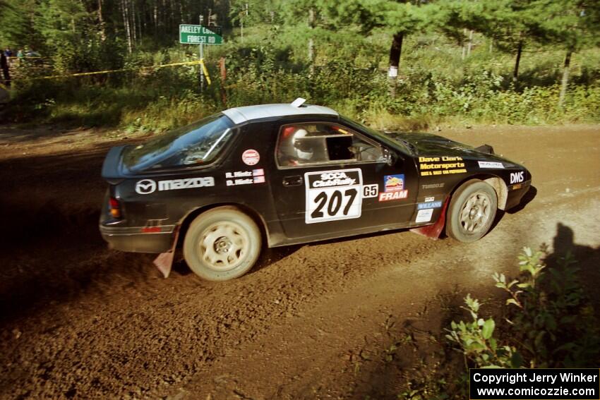 Dave Hintz / Rick Hintz Mazda RX-7 powers out of a sharp left-hander on SS13 (Steamboat).