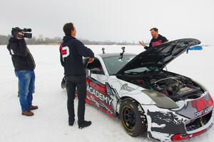 Josh Robinson is interviewed behind his Nissan 350Z.