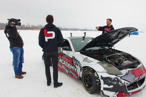 Josh Robinson is interviewed behind his Nissan 350Z.