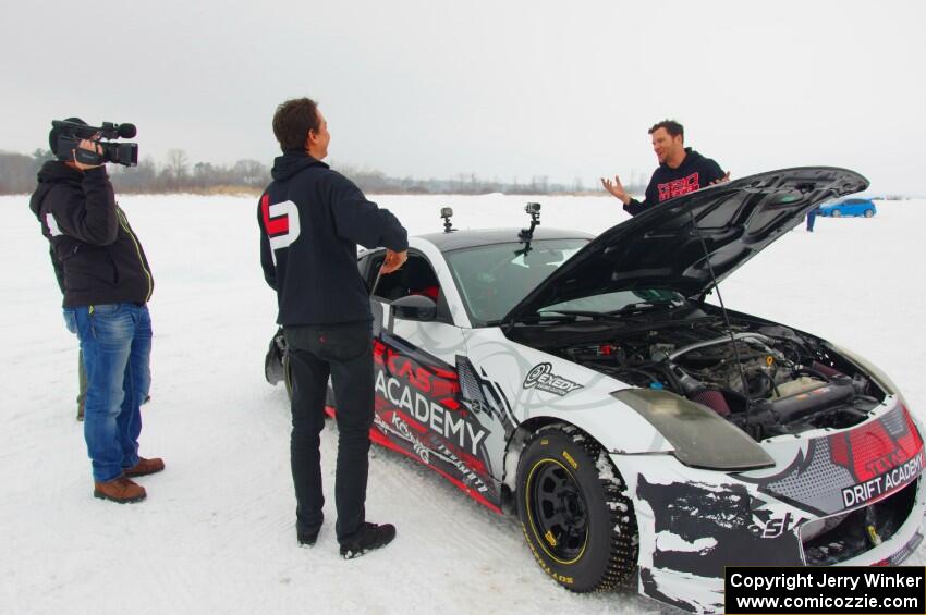 Josh Robinson is interviewed behind his Nissan 350Z.