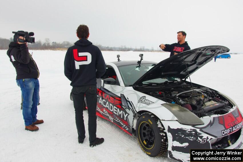 Josh Robinson is interviewed behind his Nissan 350Z.