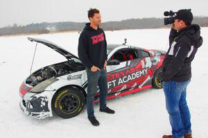 Josh Robinson is interviewed in front of his Nissan 350Z.