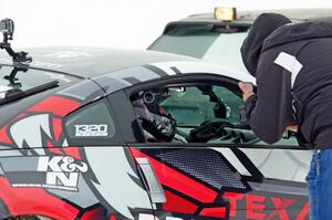 A passenger readies himself in Josh Robinson's Nissan 350Z.