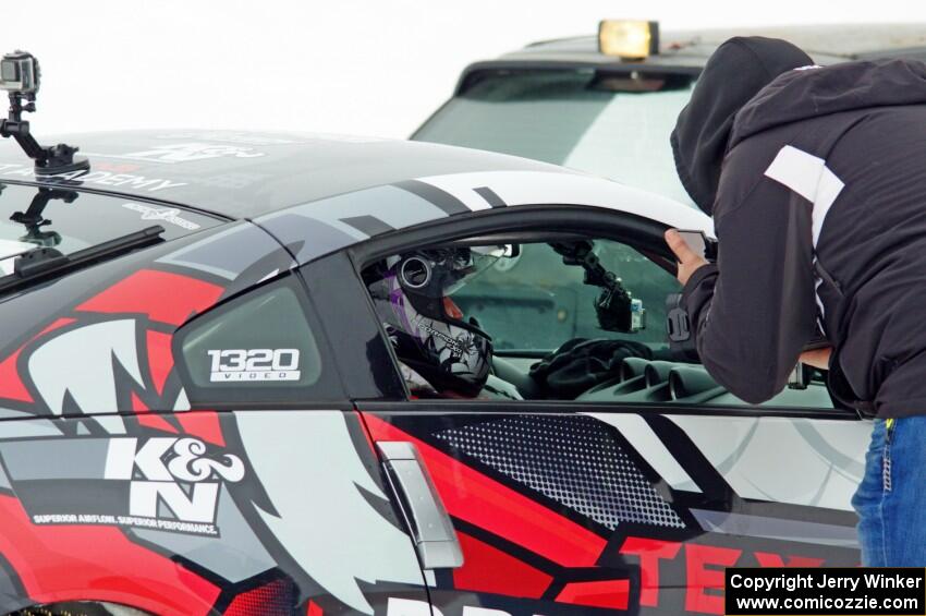A passenger readies himself in Josh Robinson's Nissan 350Z.