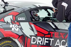 A passenger readies himself in Josh Robinson's Nissan 350Z.