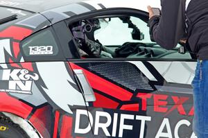 A passenger readies himself in Josh Robinson's Nissan 350Z.