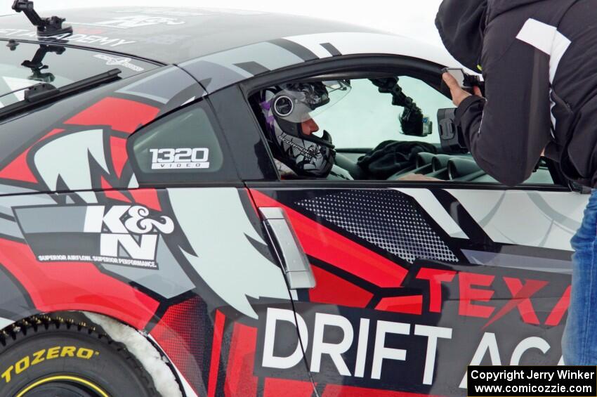 A passenger readies himself in Josh Robinson's Nissan 350Z.