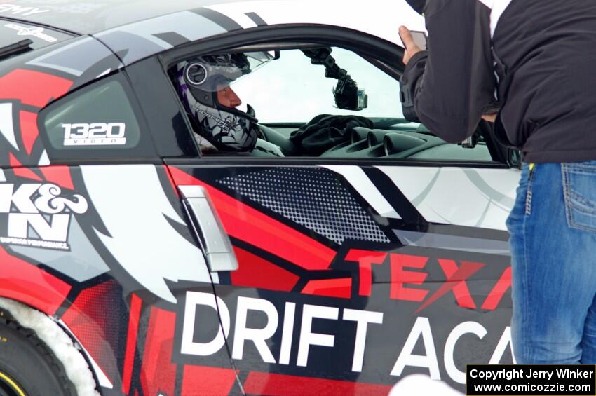 A passenger readies himself in Josh Robinson's Nissan 350Z.