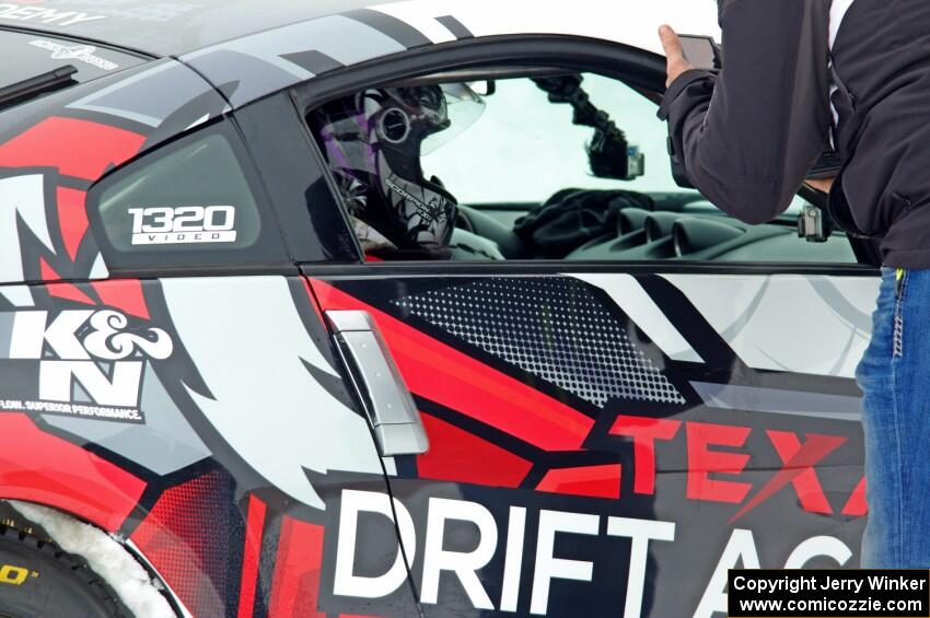 A passenger readies himself in Josh Robinson's Nissan 350Z.