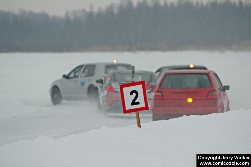 Four cars head into the first corner.