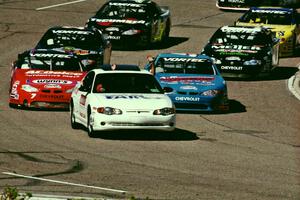 The field comes out of turn 4 led by the pace car.