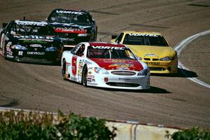 Scott Hansen's Ford Taurus leads a group