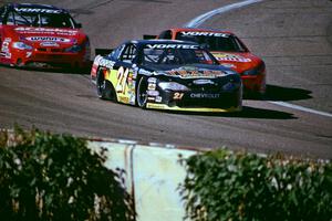 (21) Kevin Cywinski's Chevy Monte Carlo, (2) Chad Wood's Chevy Monte Carlo and Gary St. Amant's Chevy Monte Carlo