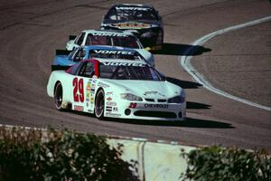 (29) Francesco Gaudesi's Chevy Monte Carlo leads three other cars out of turn 4