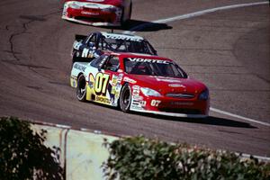 (07) Ted Smokstad's Ford Taurus and (52) Butch Miller's Chevy Monte Carlo