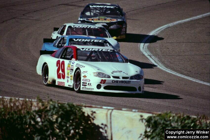 (29) Francesco Gaudesi's Chevy Monte Carlo leads three other cars out of turn 4