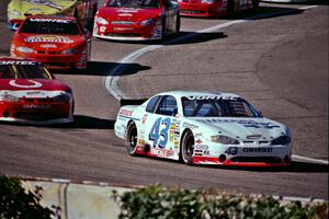 Dick Trickle's Chevy Monte Carlo leads a group of cars