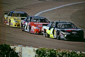 (1) Mike Garvey's Chevy Monte Carlo, (7) Gary St. Amant's Chevy Monte Carlo and (83) Joey Clanton's Chevy Monte Carlo