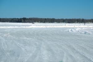 A view of the track from inside of an iceracing car.