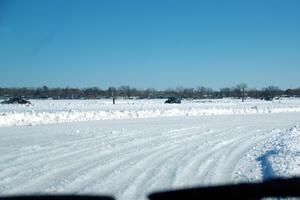 A view of the track from inside of an iceracing car.