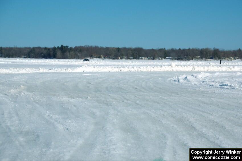 A view of the track from inside of an iceracing car.