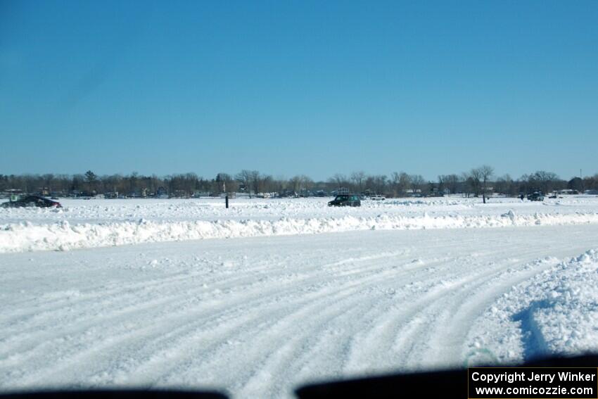 A view of the track from inside of an iceracing car.