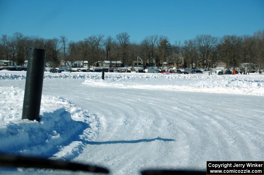 A view of the track from inside of an iceracing car.