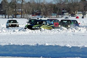 A group of cars goes through a twisty section.