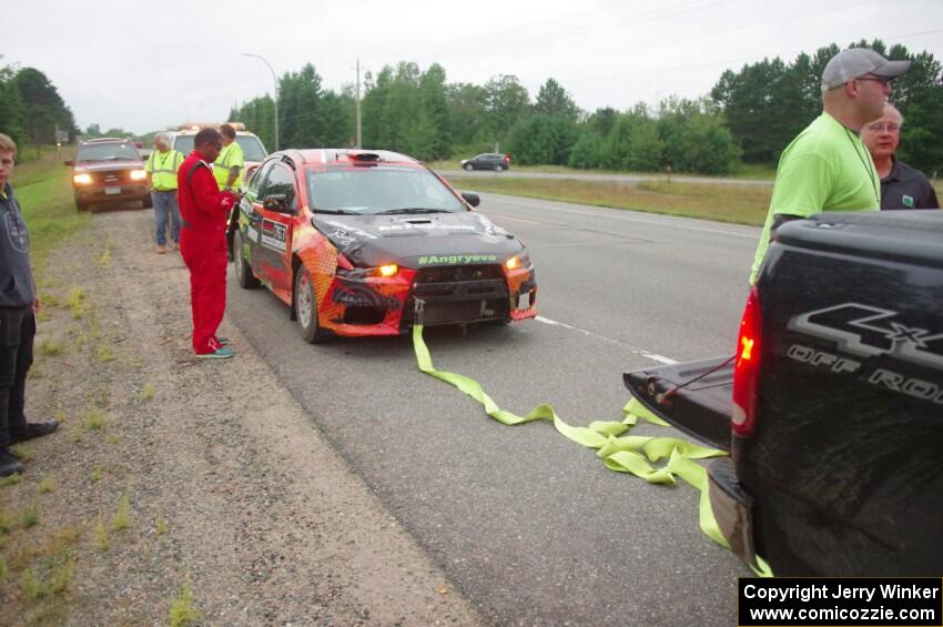 Sumit Panjabi / Nitan Jacob Mitsubishi Lancer Evo X gets readied to be towed back to Walker after rolling.