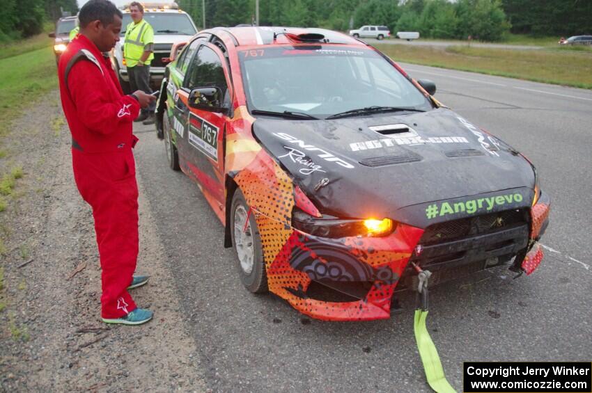 Sumit Panjabi / Nitan Jacob Mitsubishi Lancer Evo X gets readied to be towed back to Walker after rolling.