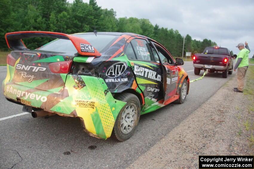 Sumit Panjabi / Nitan Jacob Mitsubishi Lancer Evo X gets readied to be towed back to Walker after rolling.