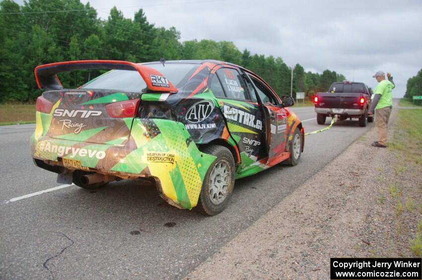 Sumit Panjabi / Nitan Jacob Mitsubishi Lancer Evo X gets readied to be towed back to Walker after rolling.