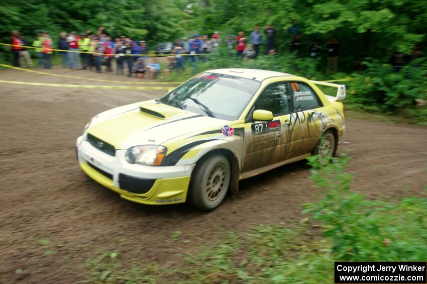 Mark Williams / Ben Peterson Subaru WRX STi comes through the VIP spectator corner on SS8, Perkins Road.