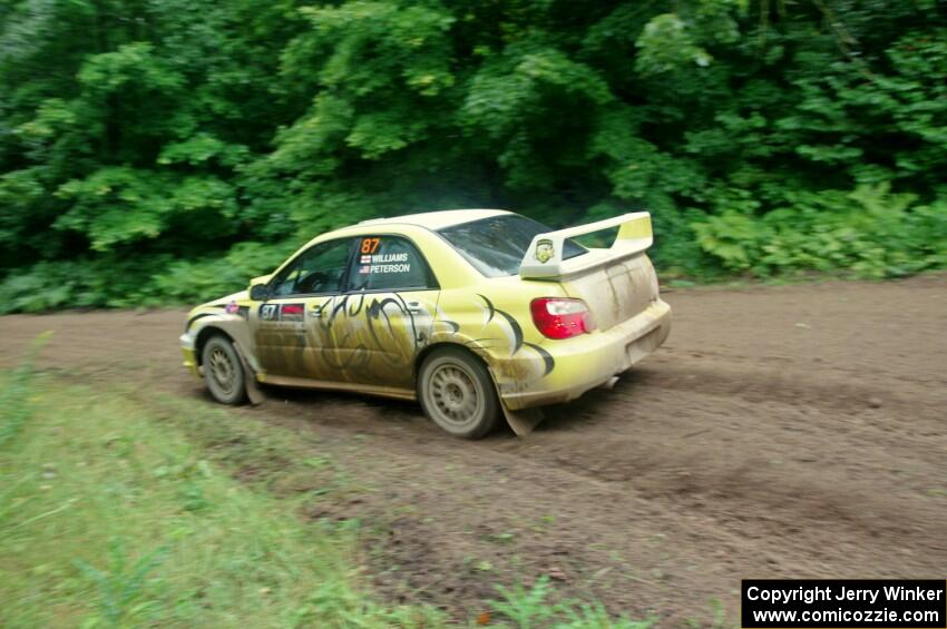 Mark Williams / Ben Peterson Subaru WRX STi comes through the VIP spectator corner on SS8, Perkins Road.