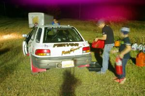 Jacob Bryant / Derek VandenBroek Subaru Impreza Outback is refueled before leaving Sidnaw service.