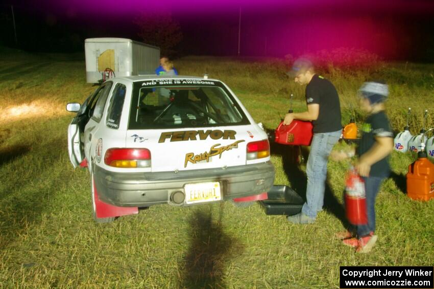 Jacob Bryant / Derek VandenBroek Subaru Impreza Outback is refueled before leaving Sidnaw service.