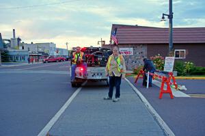 Sue Martens guides cars into the parc expose area in L'Anse.