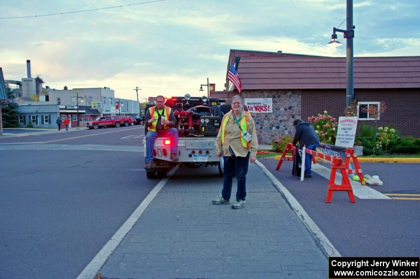 Sue Martens guides cars into the parc expose area in L'Anse.