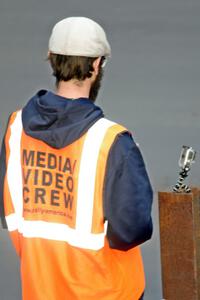 A media person readies his cameras.