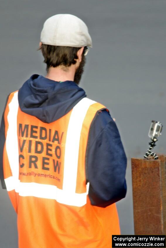 A media person readies his cameras.