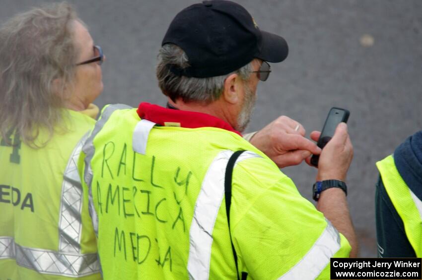 Tom Buchkoe, with an official media vest, checks on the start time.