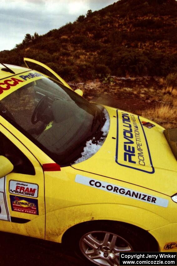 The organizer's car pulls into the finish of First View North (SS11) covered in hail.