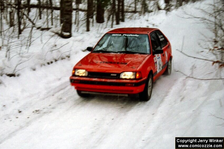 Gail Truess / Pattie Hughes-Mayer Mazda 323GTX at speed on SS1, Hardwood Hills Rd.