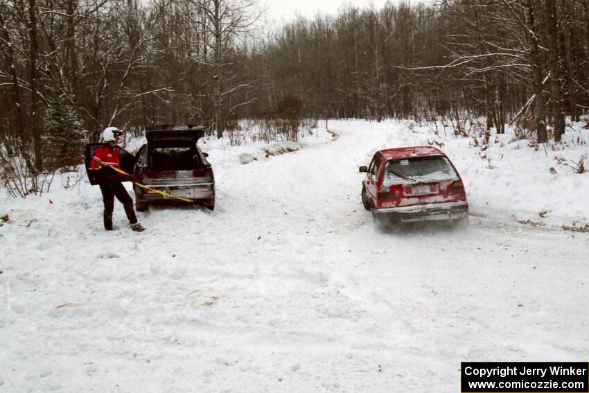 Matthew Johnson / Eric Adams VW GTI passes the stranded Dennis Martin / Chris Plante Mitsubishi Eclipse GSX on SS1.