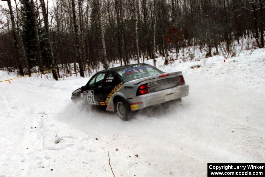 Anthony Grinnell / Kim Young Chevy Beretta goes straight off at a sharp corner on SS1, Hardwood Hills Rd.